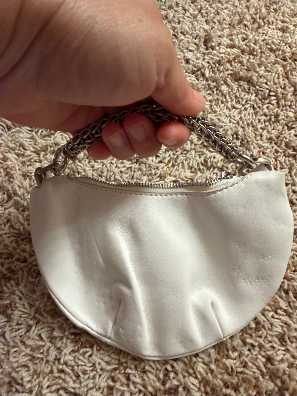 accessory is a crescent-shaped or baguette-style handbag from Urban Outfitt